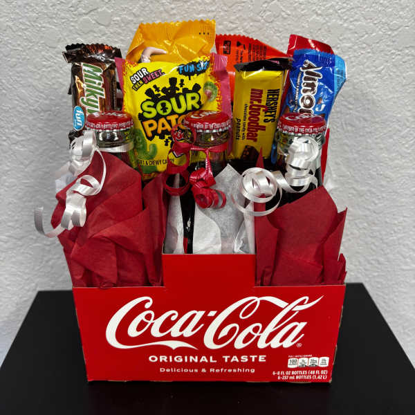 Coca-Cola gift box filled with assorted candy and ribbon curls