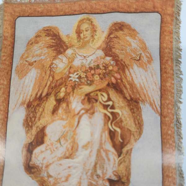 Decorative angel figure holding a bouquet of flowers