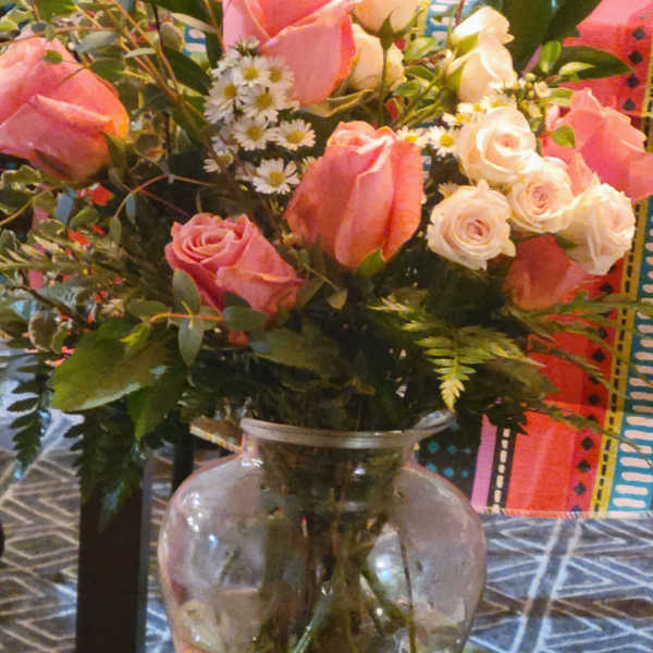 Pink and white roses in a clear glass vase