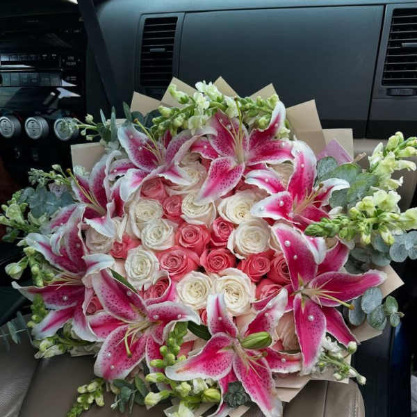 Bouquet of pink and white roses with pink lilies