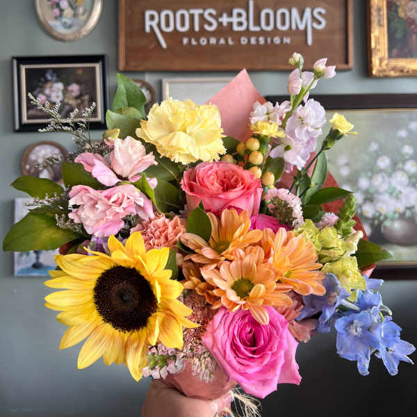 Colorful mixed bouquet with sunflowers, roses, and pastel blooms