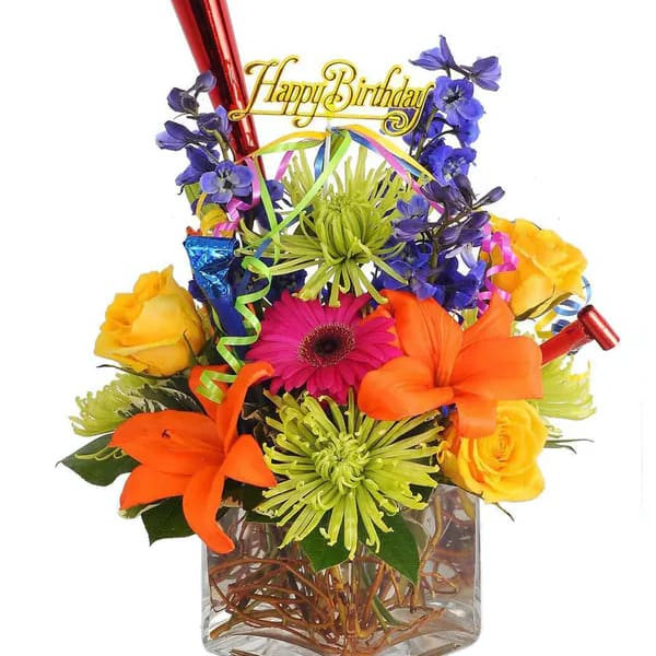 Colorful birthday bouquet in a glass vase with a "Happy Birthday" topper