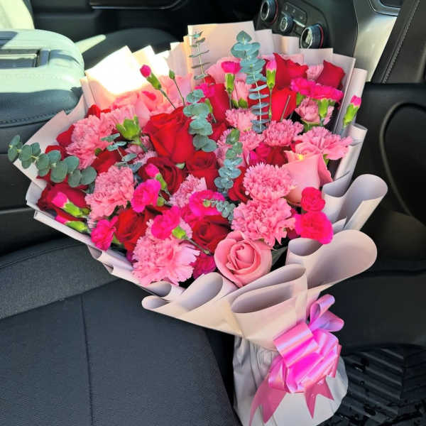 Bouquet of red and pink roses with carnations and eucalyptus