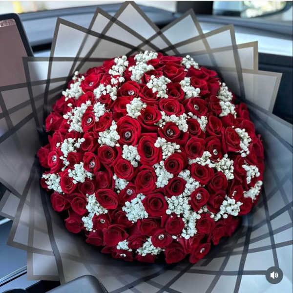 Round bouquet of red roses with white baby's breath
