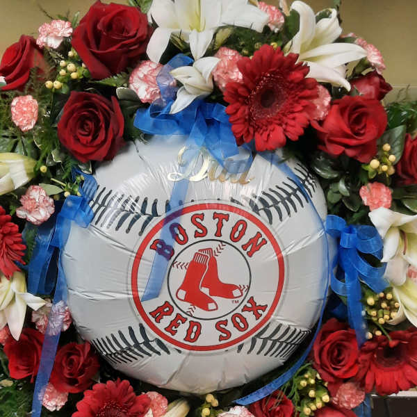 Red and white floral wreath around a Boston Red Sox balloon
