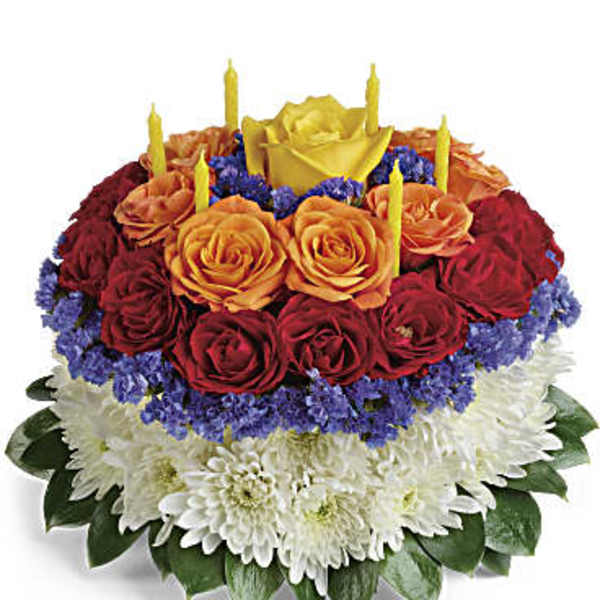 Round bouquet of red and orange roses with white chrysanthemums and candles