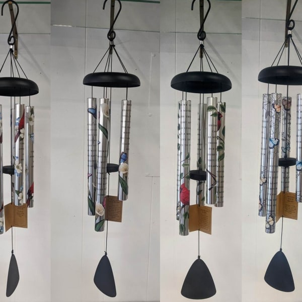 Six hanging metal wind chimes with floral patterns and black tops