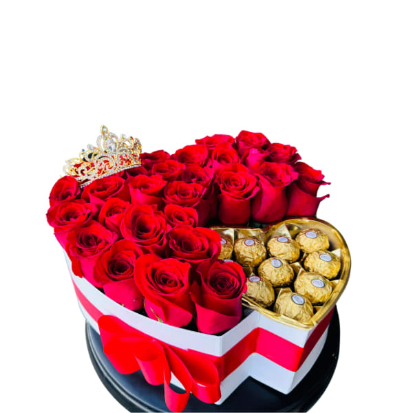 Heart-shaped box of red roses and gold-wrapped chocolates with a jeweled crown accent.