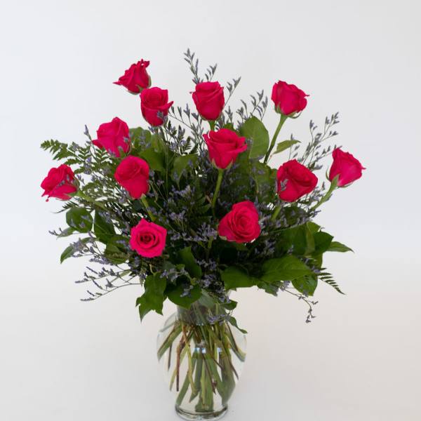 Pink roses arranged in a clear glass vase