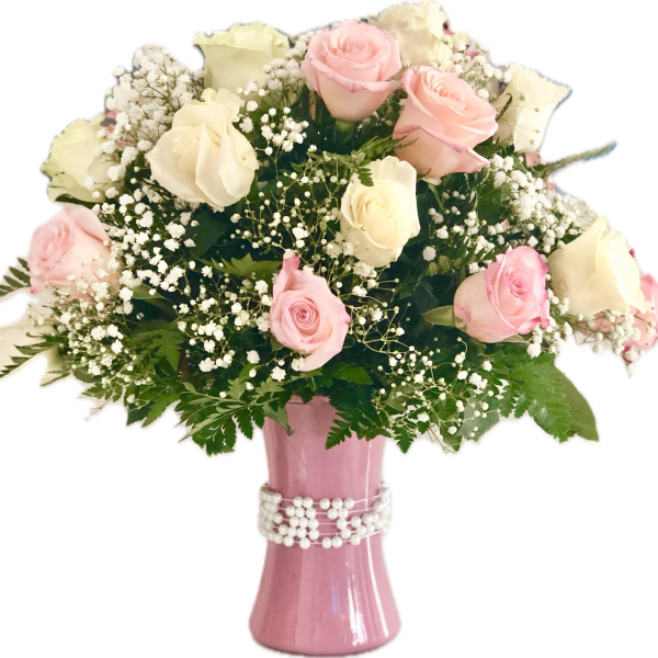 Pink and white roses in a pink vase with baby's breath