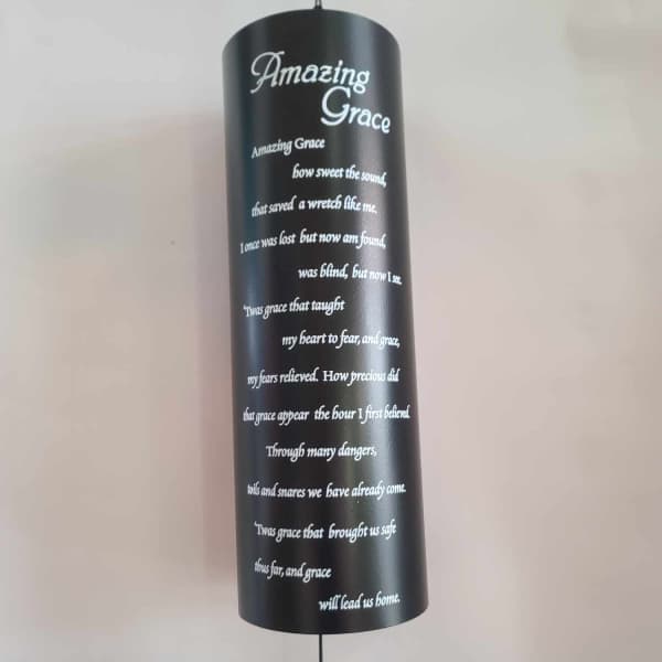 Black hanging memorial plaque with white "Amazing Grace" text