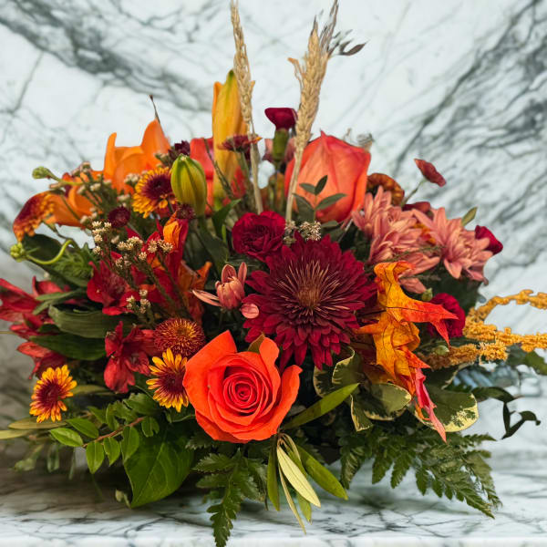 Autumn bouquet with orange roses and burgundy chrysanthemums