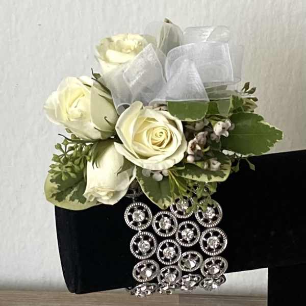 Cream roses with greenery and a jeweled black wrap
