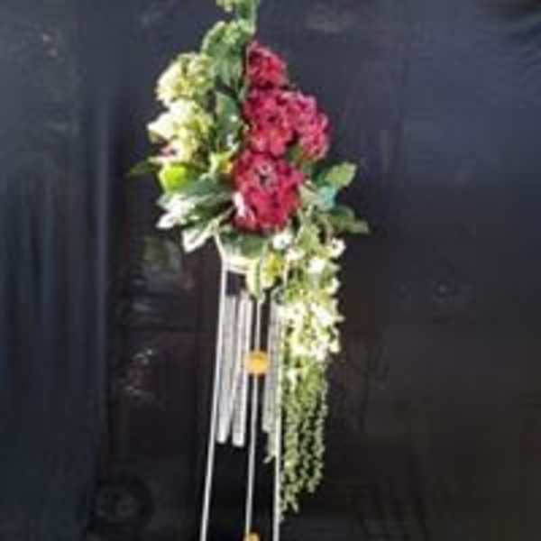 Tall floral standing arrangement with pink and white flowers on a metal stand