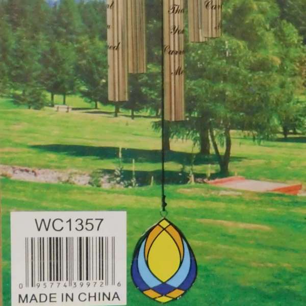 Decorative wind chime with a lighthouse medallion and hanging metal tubes