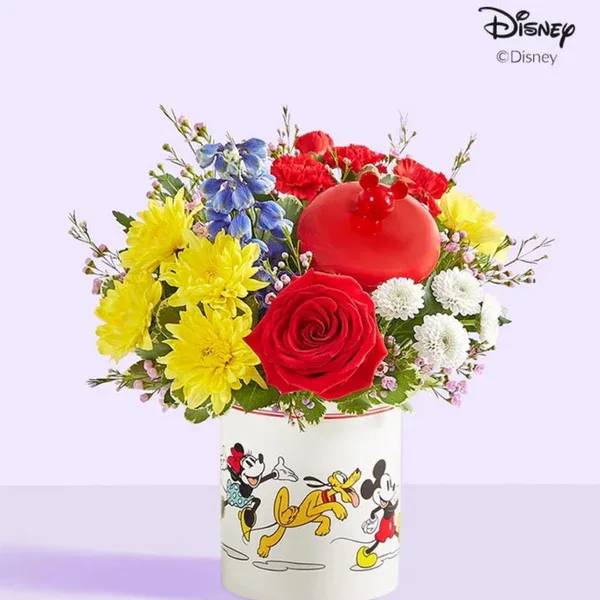 Colorful bouquet in a Mickey Mouse vase with a red ornament