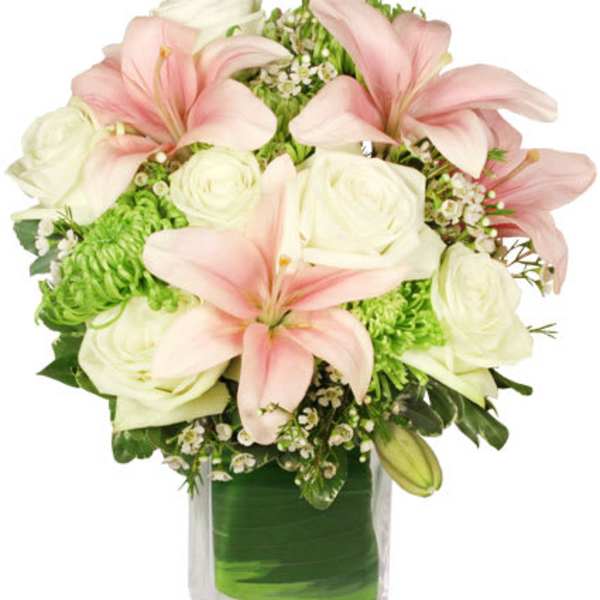 Pink lilies and white roses arranged in a clear vase