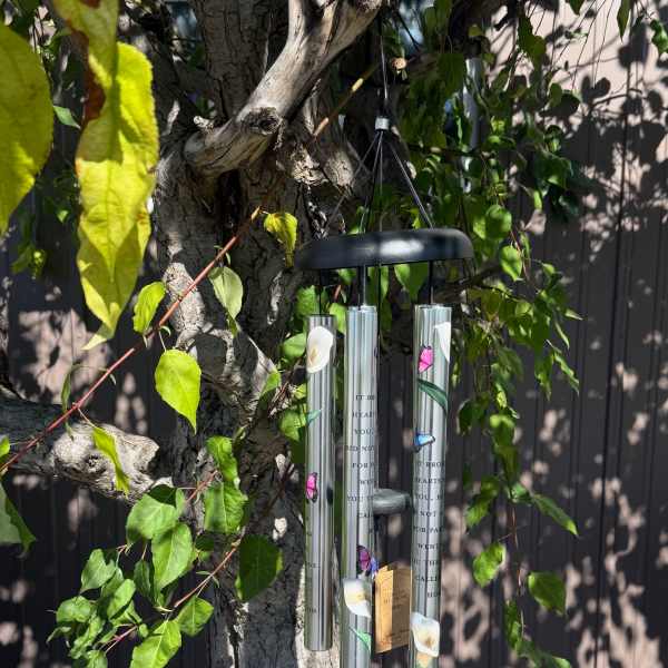 Hanging metal wind chime on a tree branch