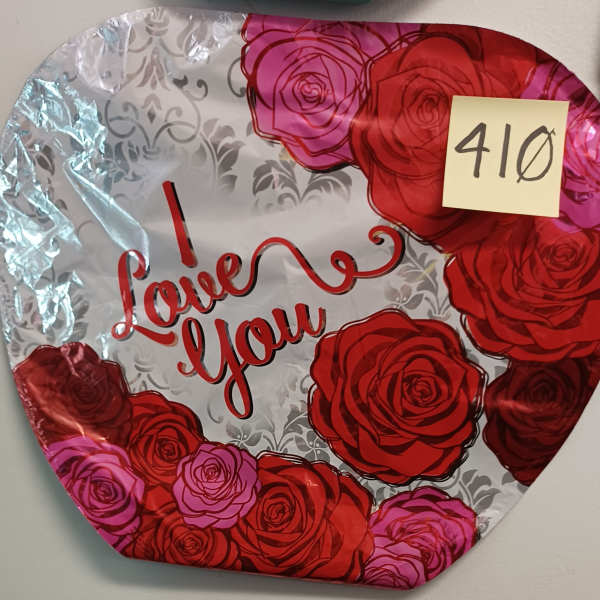 Heart-shaped foil balloon with roses and "I love you" text