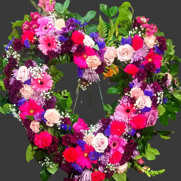 Heart-shaped floral wreath with pink, purple, and white flowers