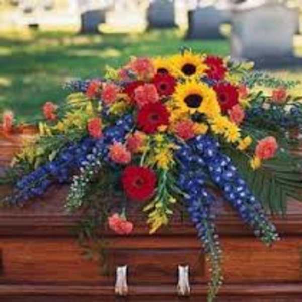 Colorful floral spray arranged on a casket