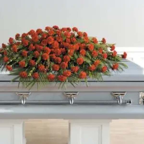 Red floral spray on top of a casket