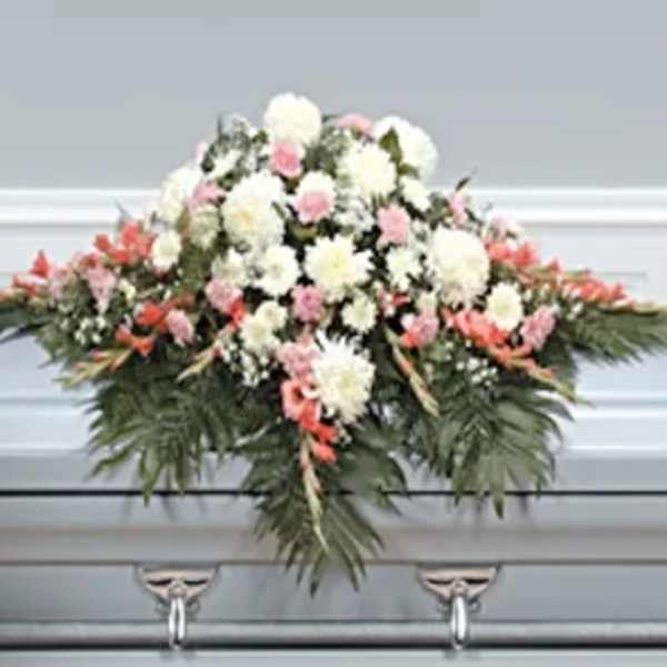 Casket spray with white and pink flowers and greenery