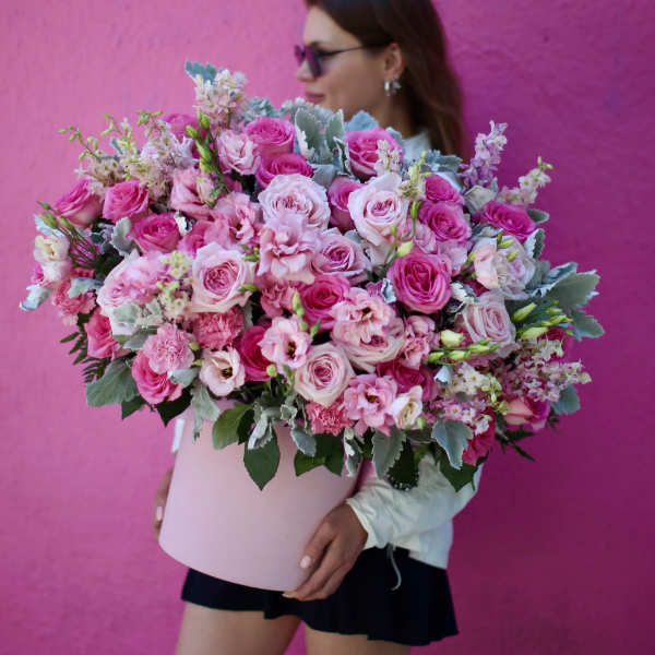 Large pink bouquet of roses and carnations in a pale box