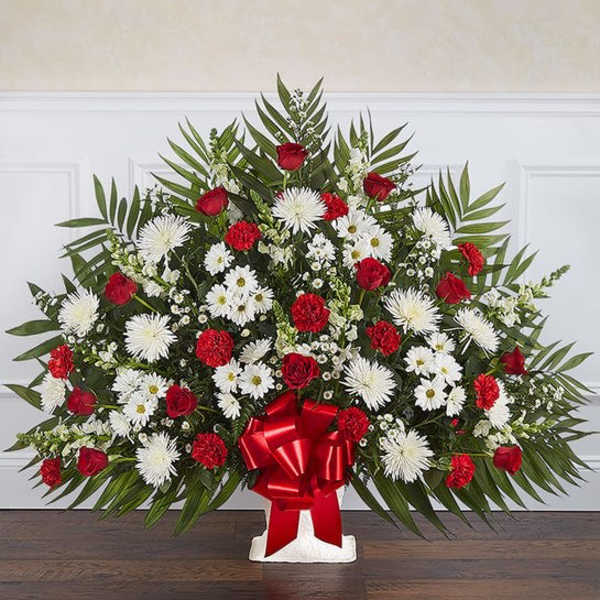 Large red and white floral spray with a red ribbon bow