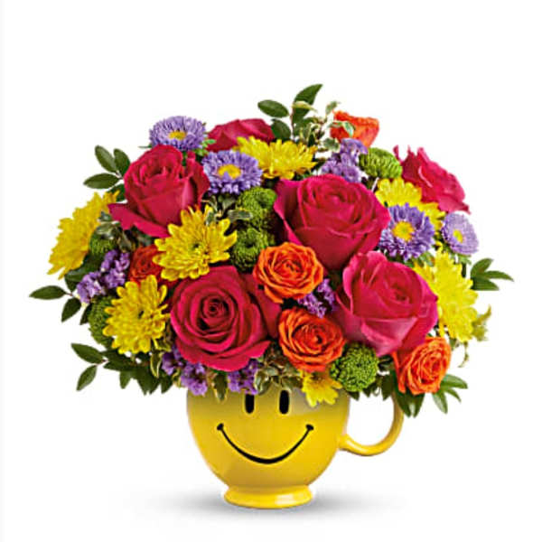Colorful bouquet in a yellow smiley-face mug