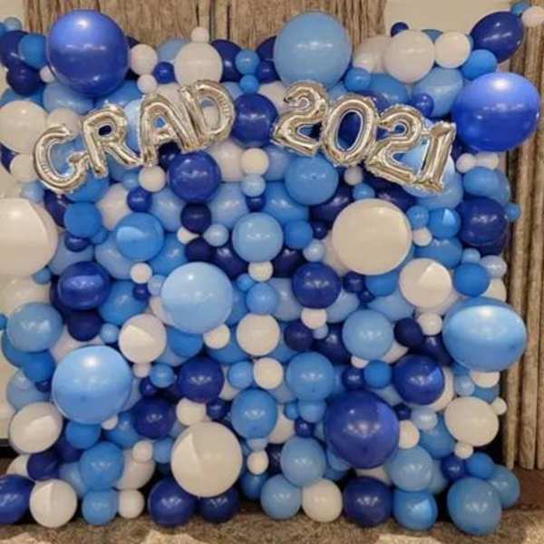 Blue and white balloon backdrop with silver "GRAD 2021" letters