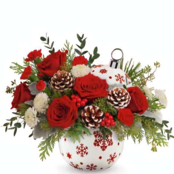 Red roses and white flowers arranged in a snowflake ornament vase