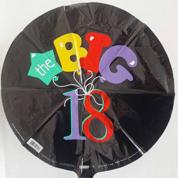 Black round balloon with colorful "the BIG 18" text