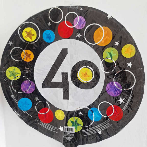 Round black balloon with a large white 40 and colorful circles