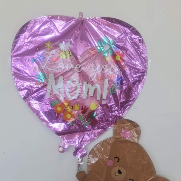 Pink heart balloon with "Love you Mom!" and a teddy bear balloon