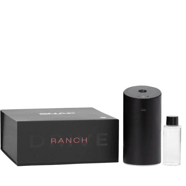Black diffuser, bottle, and box set on a plain background