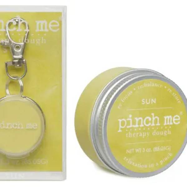 Yellow tin of therapy dough with a keychain in packaging