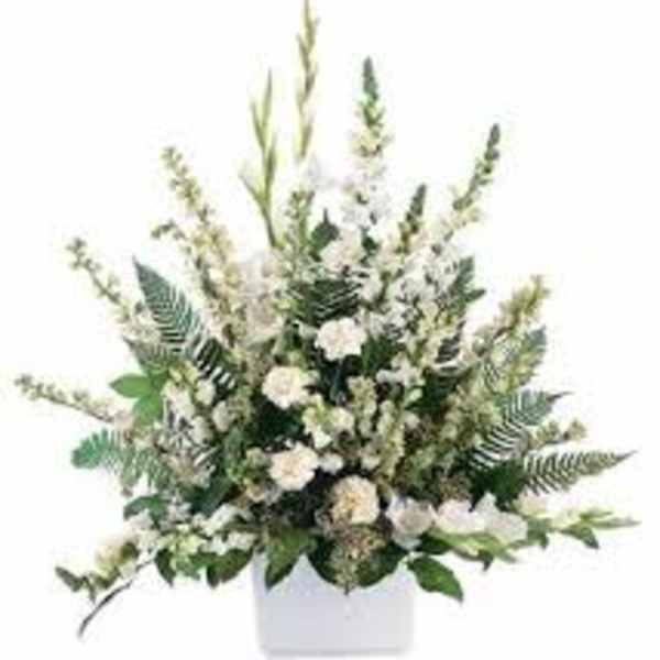 White floral arrangement in a white container