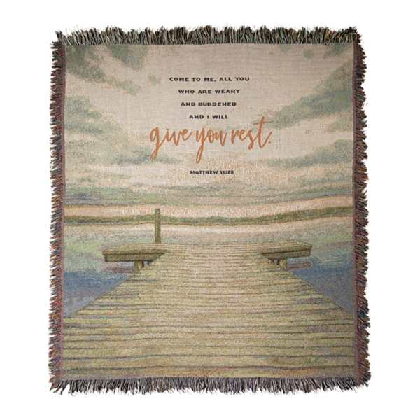 Fringed woven blanket with a dock scene and Bible verse text