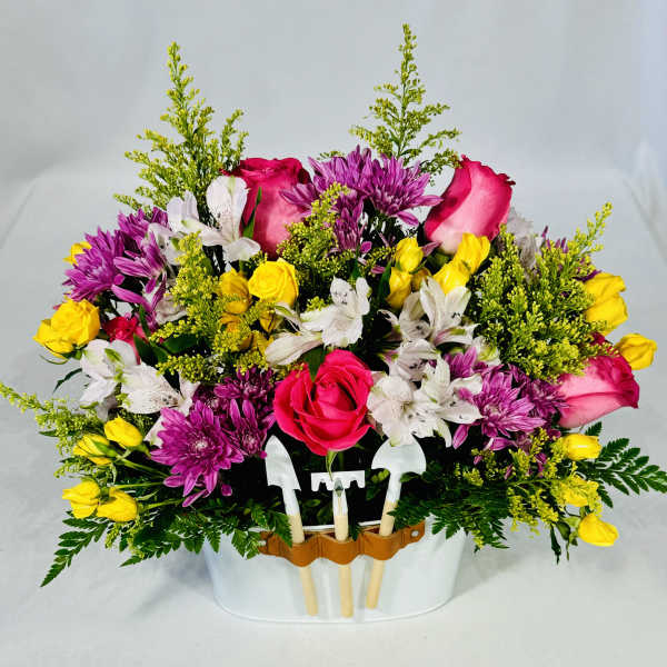 Mixed bouquet of roses, chrysanthemums, and alstroemeria in a white container