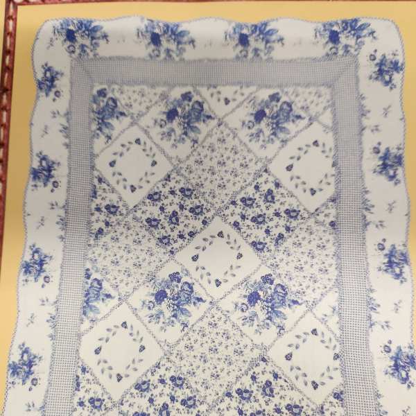 Blue-and-white floral quilt with patchwork diamond pattern