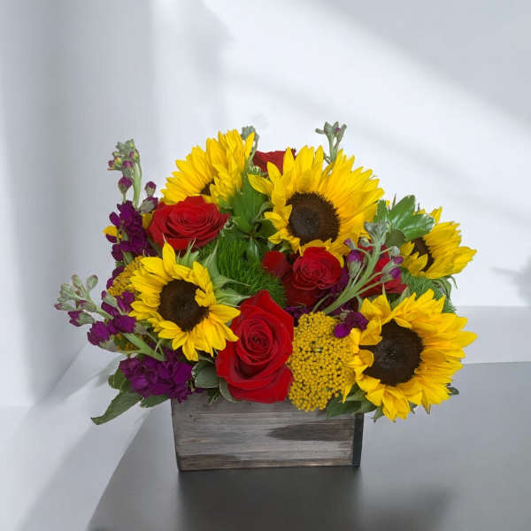 Sunflower and red rose arrangement in a wooden box