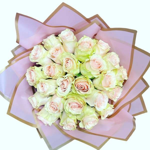 Bouquet of pale pink roses wrapped in lavender paper
