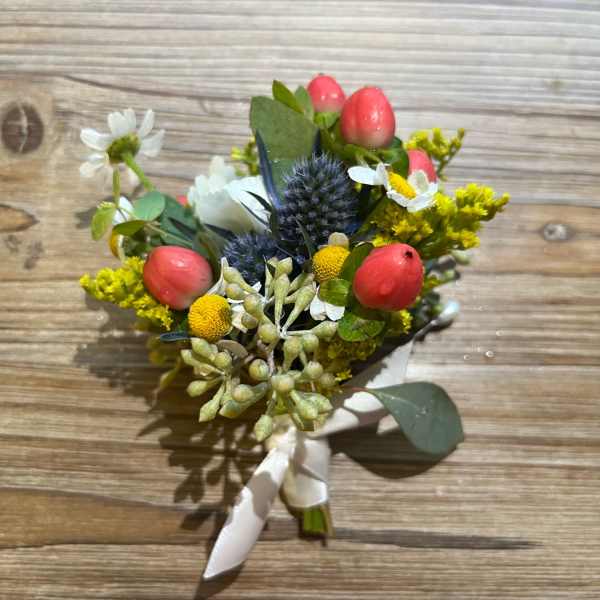 Small bouquet with pink tulips, white daisies, and blue thistle