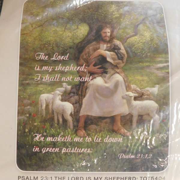 Religious card with Jesus holding a lamb and sheep in a pastoral scene