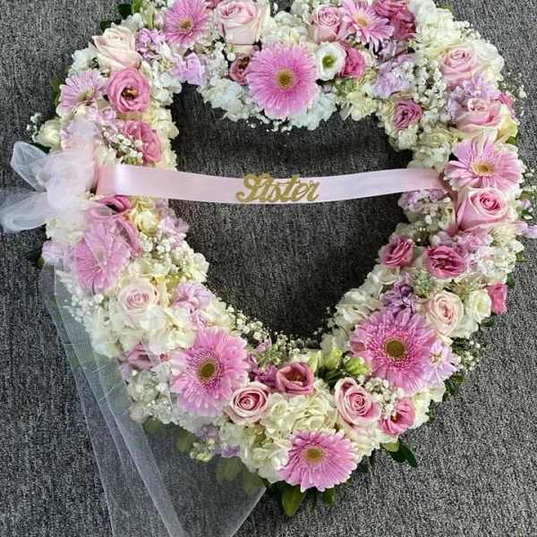 Heart-shaped floral wreath with pink roses and gerbera daisies