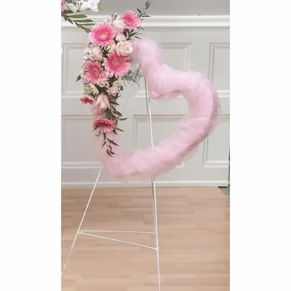 Pink floral heart wreath on a metal stand with tulle wrap