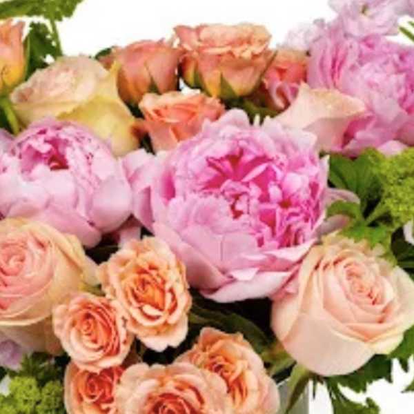Pastel bouquet with pink peonies and peach roses accented by fern fronds
