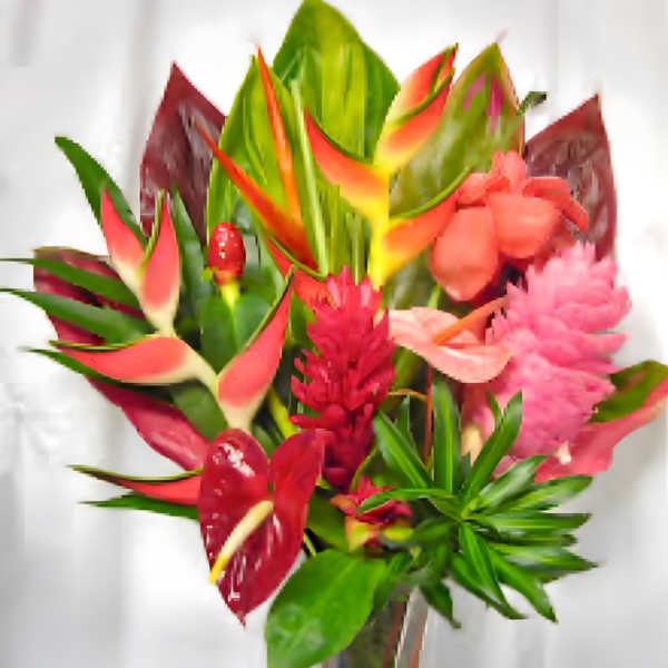 Tropical bouquet with red and pink flowers and broad green leaves