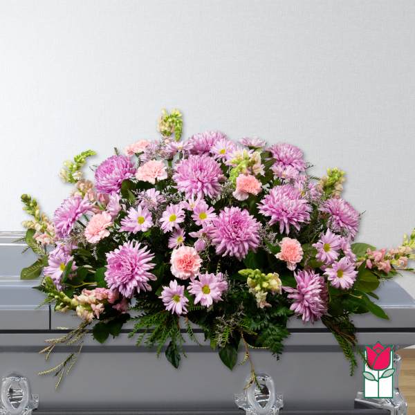 Pink and lavender floral casket spray with daisies and carnations